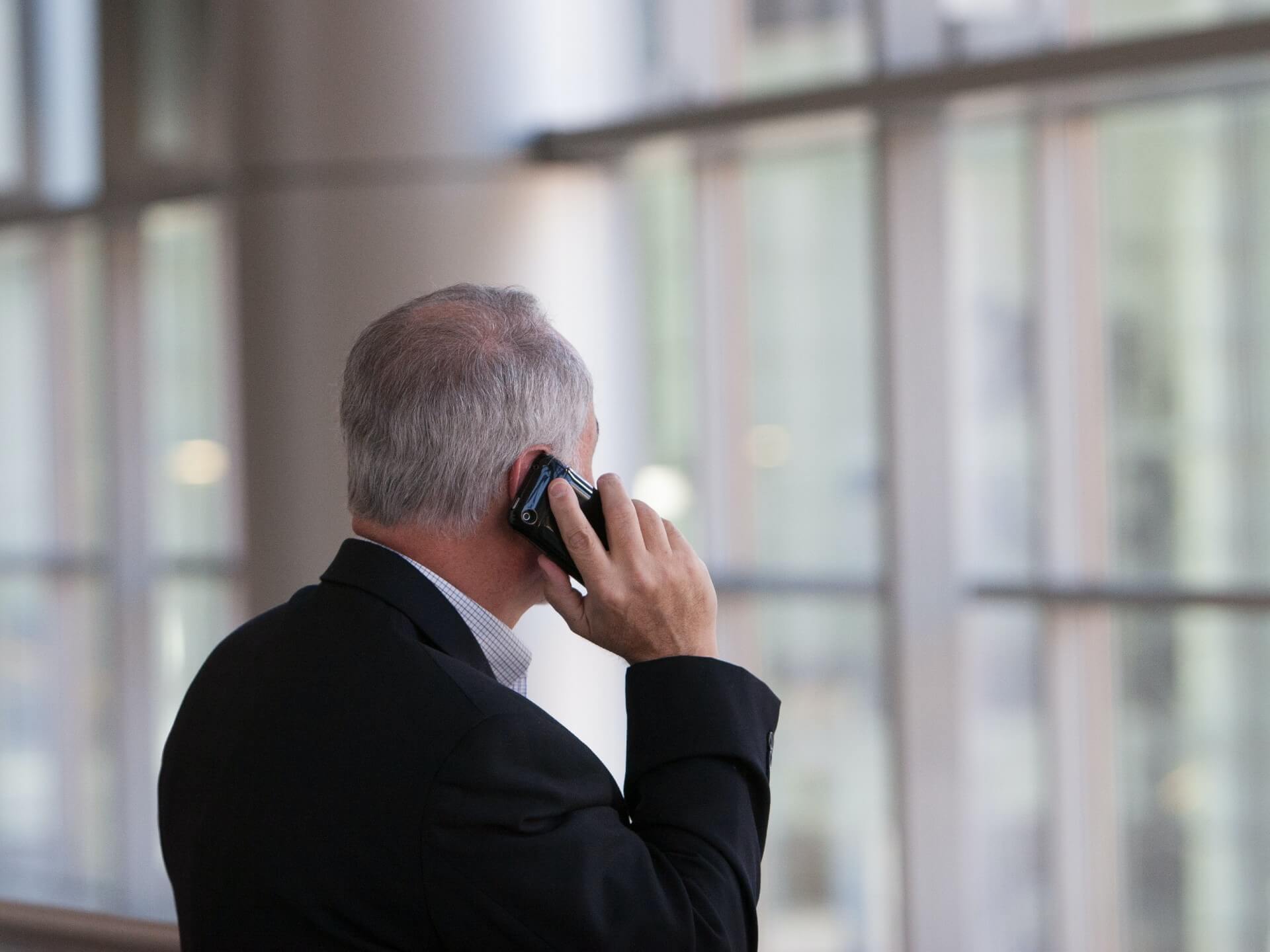older man making a phone call to ConciMed to book his Podiatry consultation