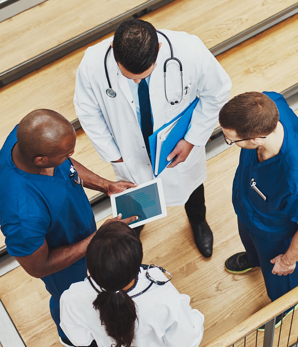 doctors discussing patient treatment before presenting it to their podiatry patient