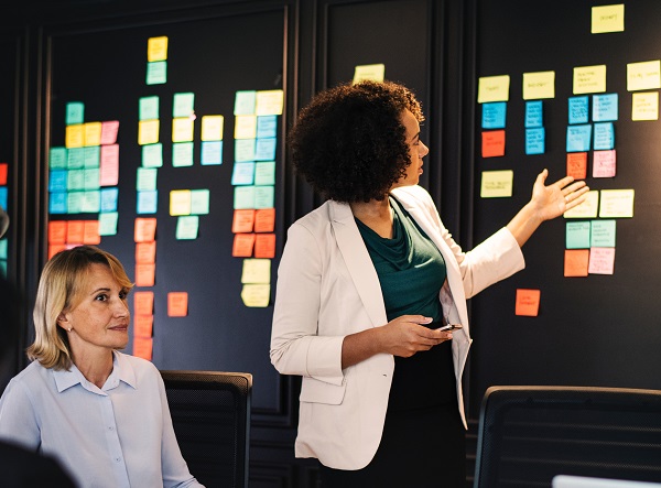 diverse office workers looking at post it notes