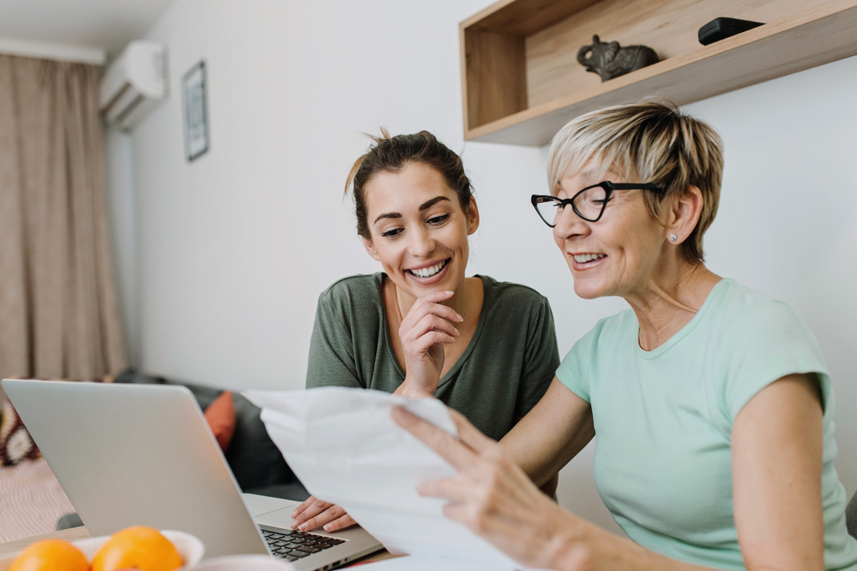 Two women look at medical bills photo