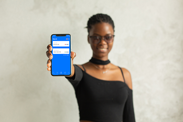 black women holding phone with Afriex App open