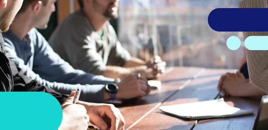 People having a discussion around a meeting table