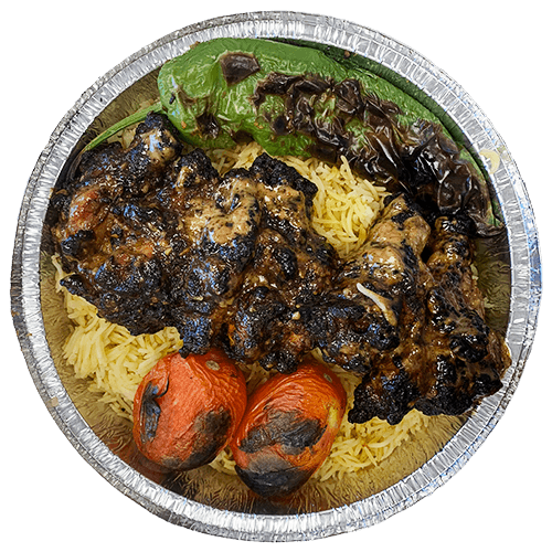 An image of grilled chicken wings on a bed of Saffron Basmati Rice with two grilled tomatoes and a grilled Poblano pepper.