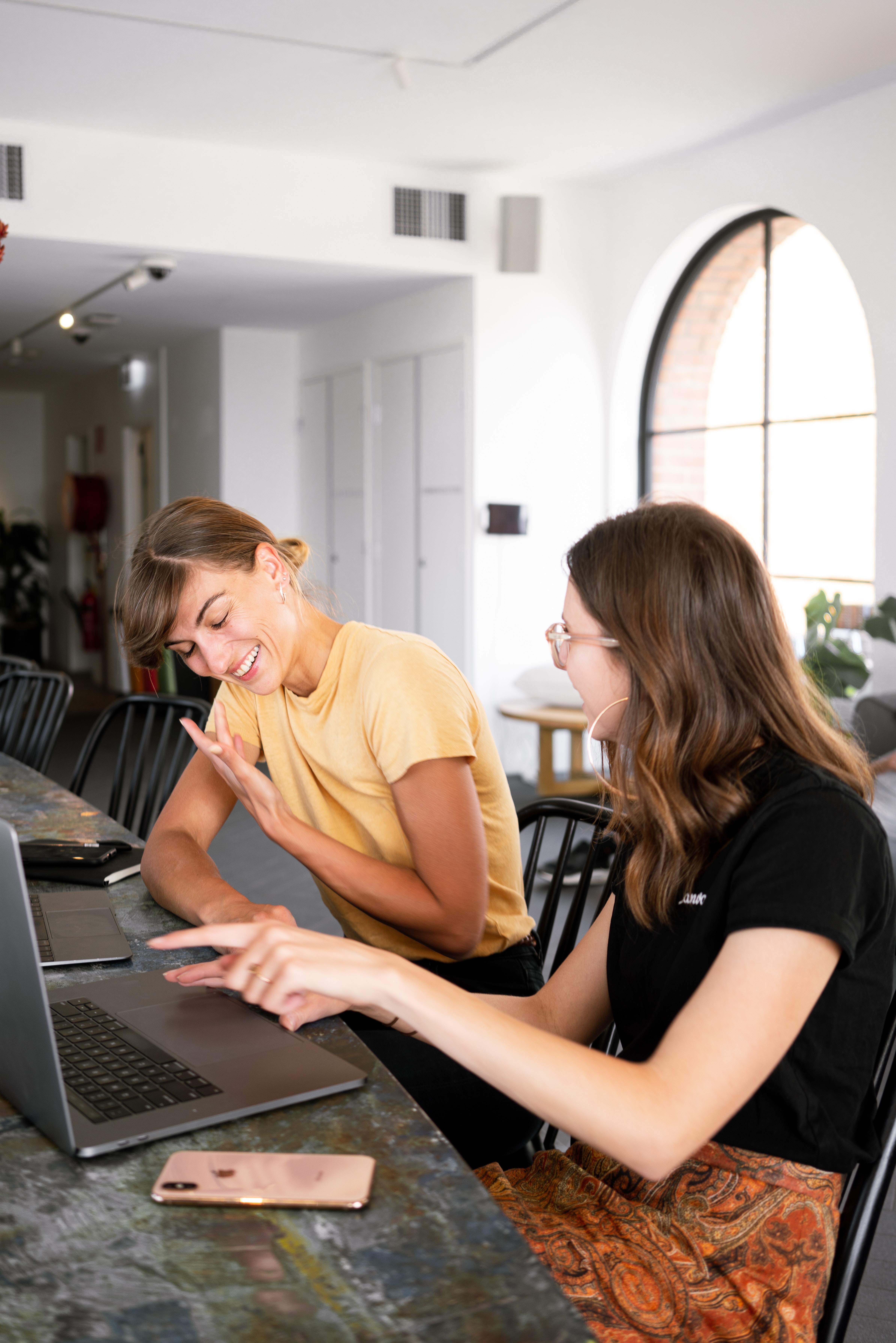 Two women having a discussion in front of a PC