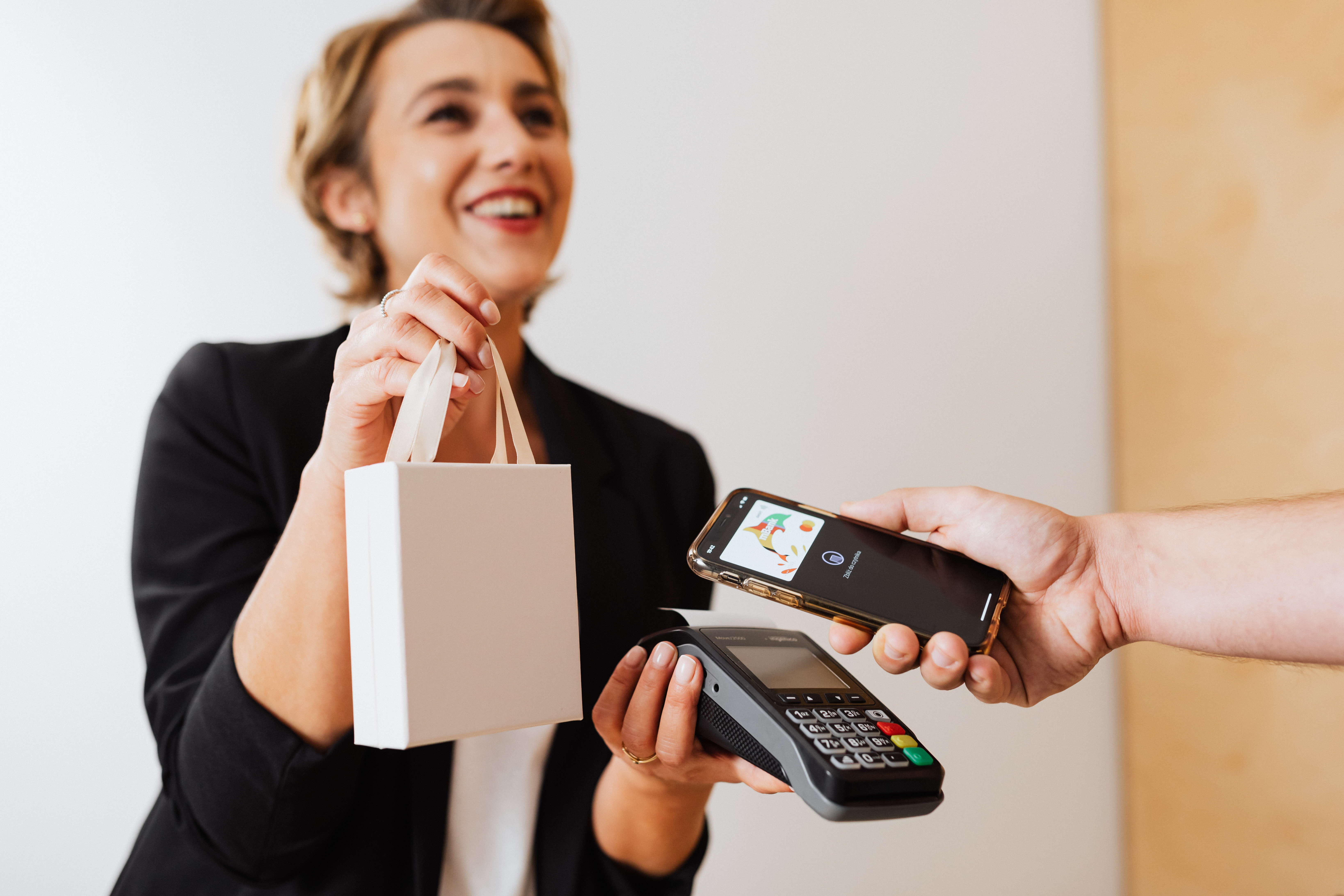 A woman receiving cashless payment using smart phone