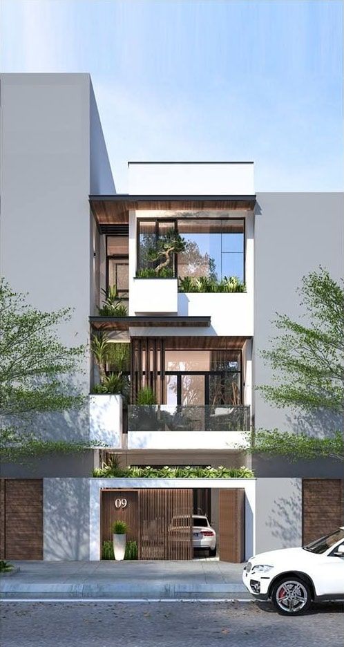 hình ảnh mặt tiền mẫu nhà 3 tầng với chất liệu gỗ chủ đạo, ngập tràn các loại cây cảnh