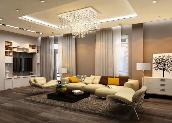 hình ảnh phòng khách biệt thự với bộ ghế sofa màu trắng sữa, gối tựa màu vàng, đèn chùm pha lê lớn, tủ kệ tivi màu trắng