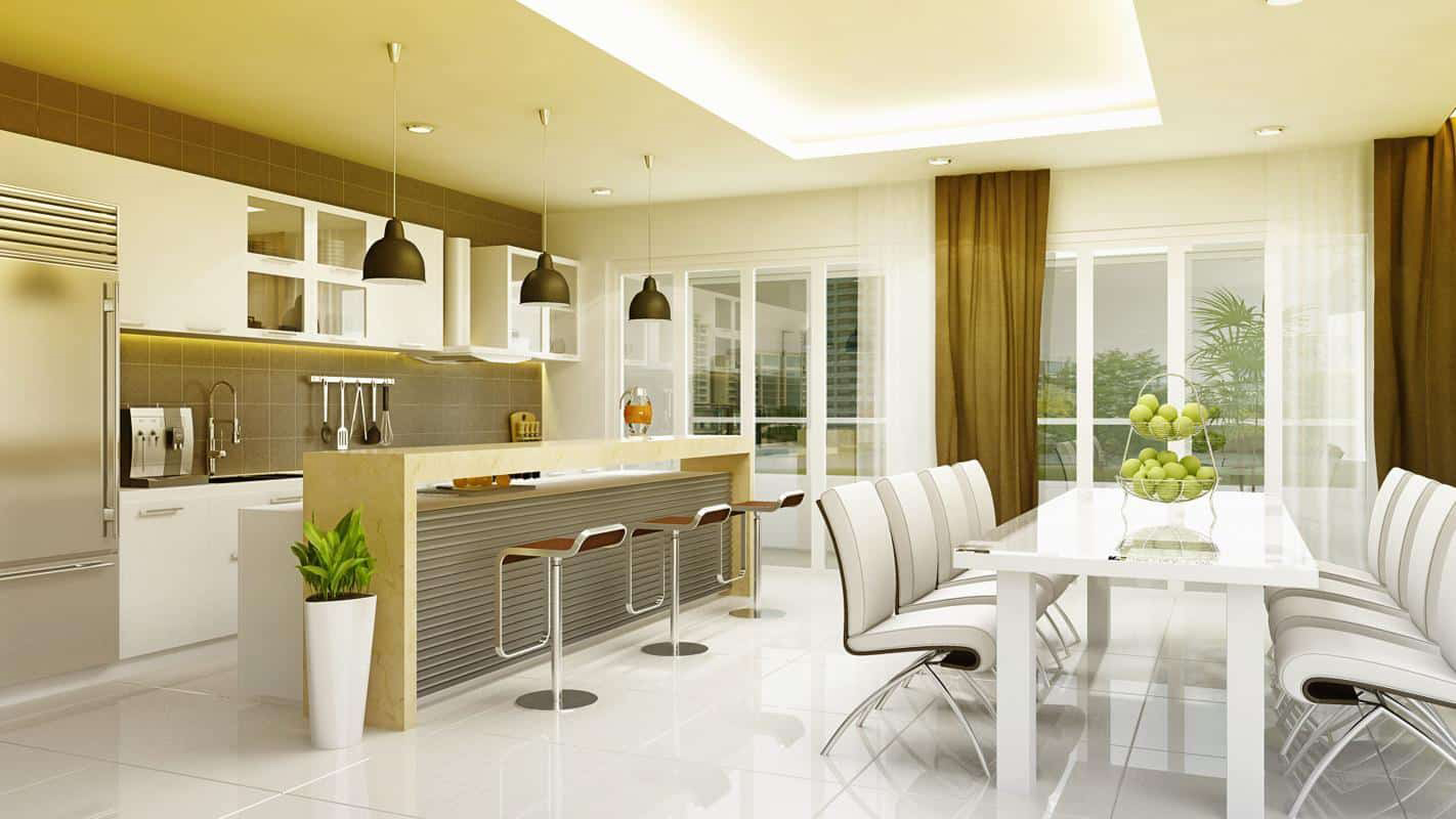 Hình ảnh toàn cảnh phòng bếp kết hợp phòng ăn hiện đại với bàn ghế ăn màu trắng, đối diện là đảo bếp kiêm quầy bar mini, phía trên treo bộ ba đèn thả có phần chụp màu đen.
