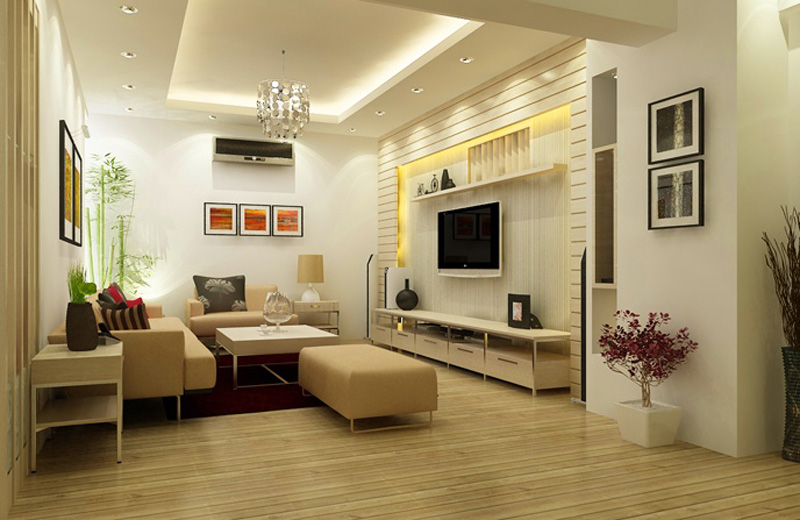 Hình ảnh toàn cảnh mẫu phòng khách tông màu be với ghế sofa lớn, kệ tivi màu trắng, bàn trà đặt ở trung tâm, tranh treo từng đèn chùm độc đáo, cửa kính lấy sáng.