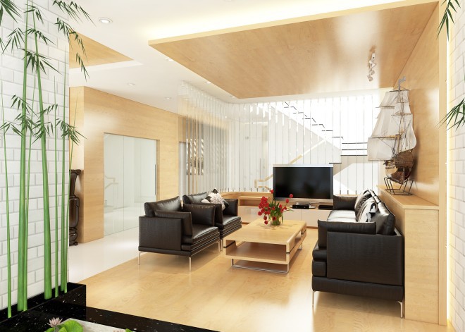 Không gian sử dụng tông màu gỗ kết hợp sofa chất liệu giả da màu đen theo phong cách hiện đại