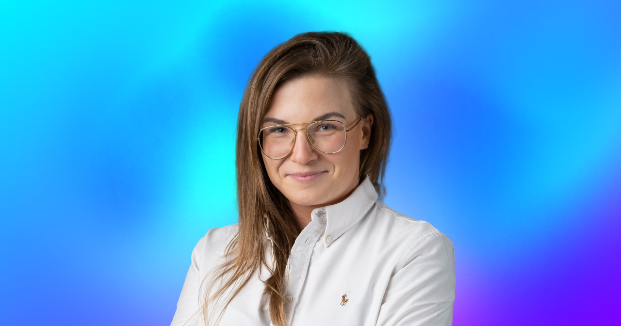 A profile picture of a lady in business attire on a colorful background.