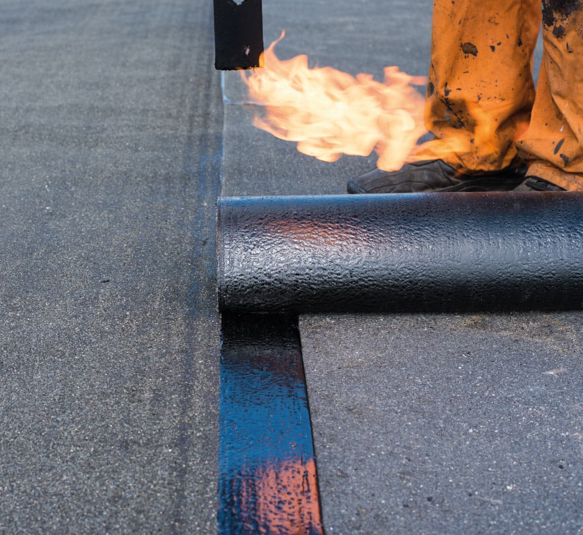 Man blowtorches a pipe