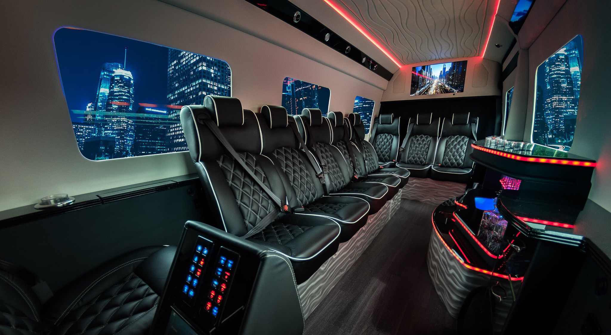 Inside of a party bus with a mini bar and red LED lights