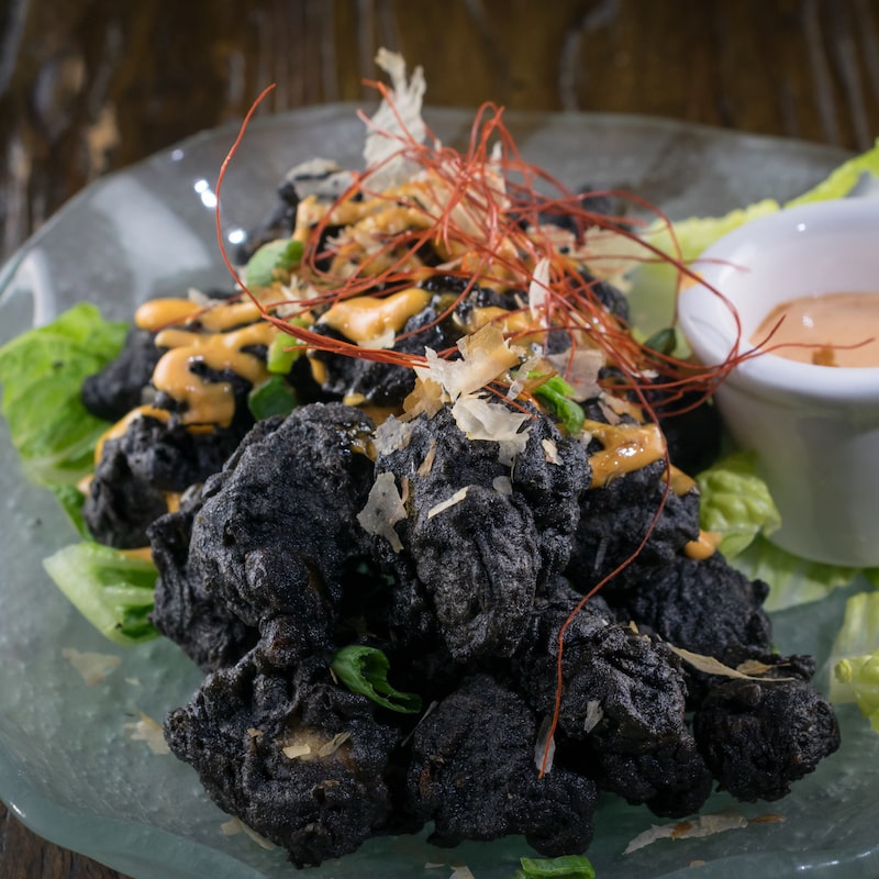 MIKHUNA's Volcano Rock Shrimp. Fried Shrimp tempura with squid ink for a deep black color.