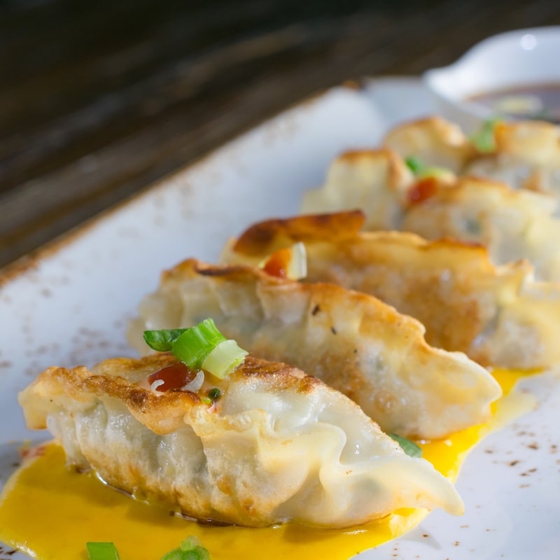 Gyoza filled with vegetables and, pork, and aji amarillo
