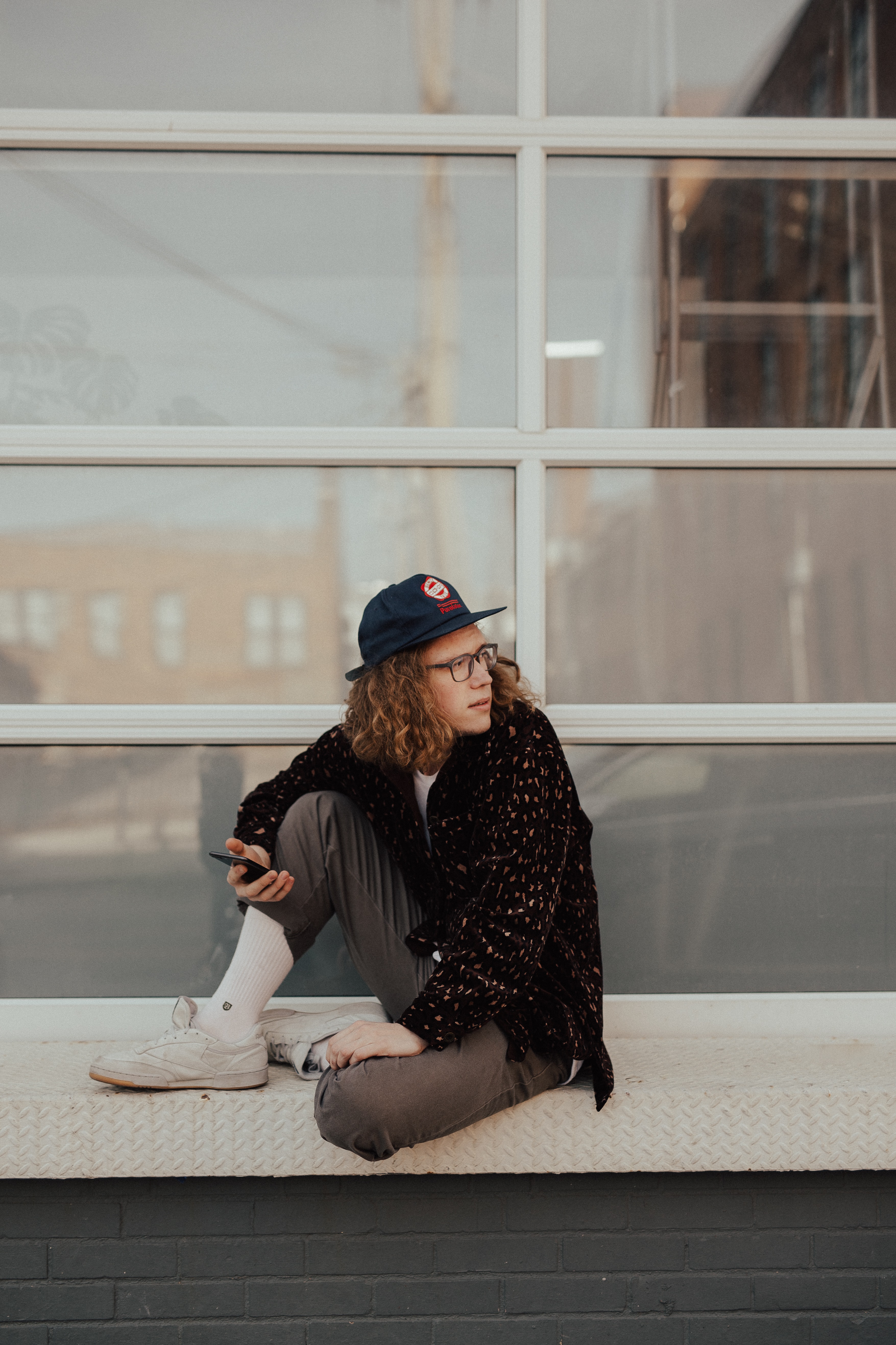 young man sitting on ledge