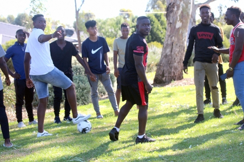 Guys playing soccer.