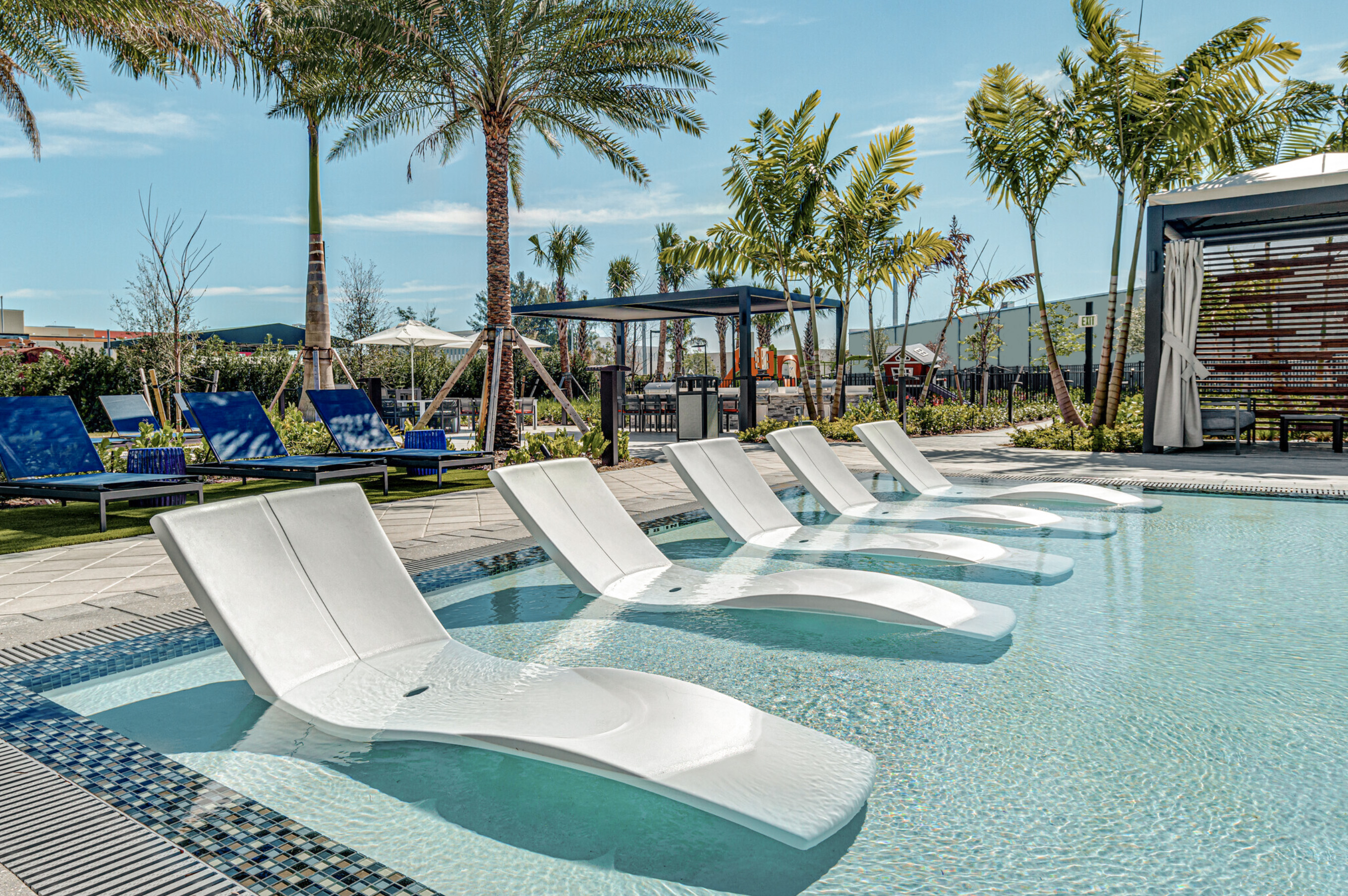 Pool Lounge chairs cabana and palm trees