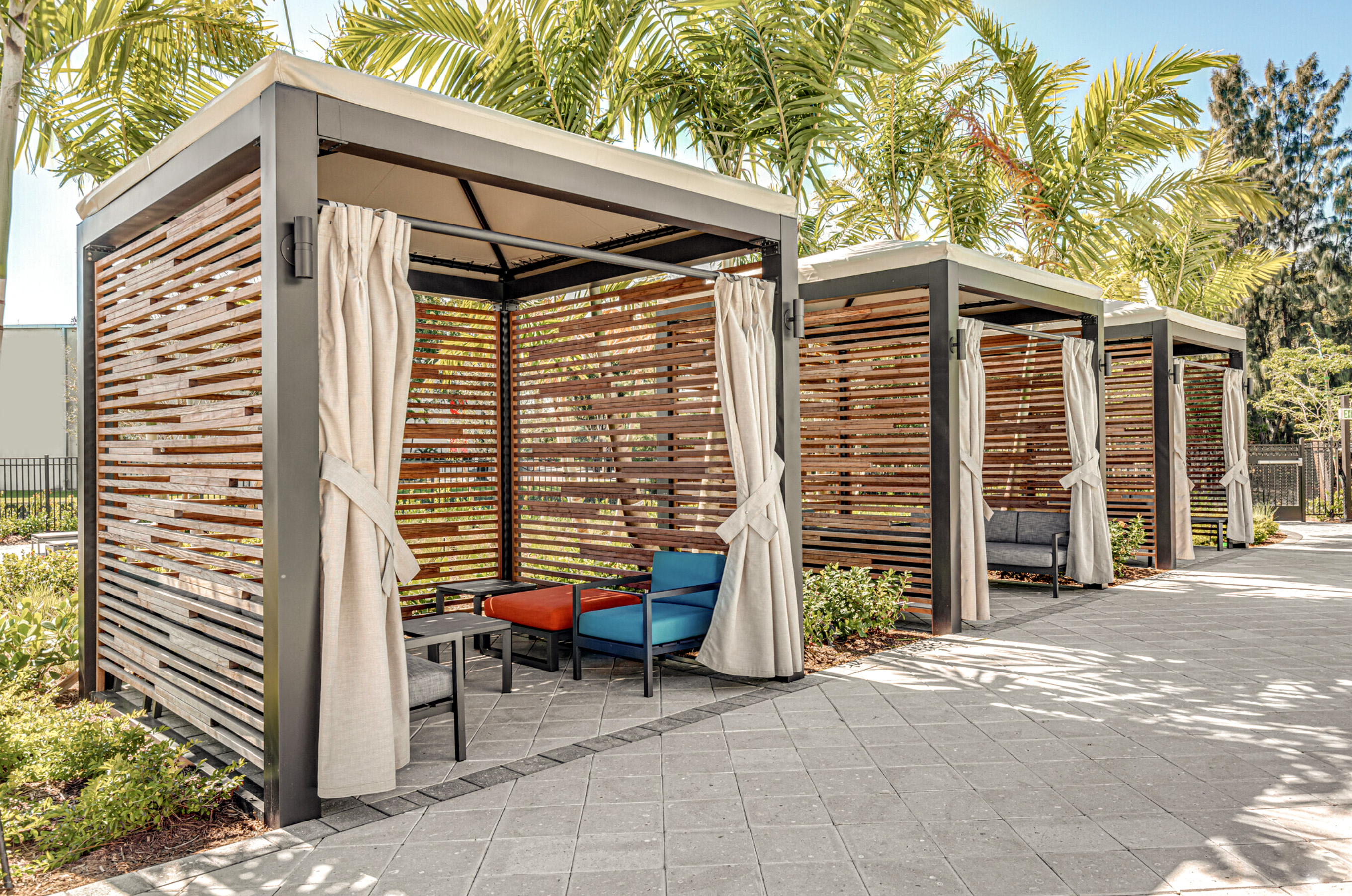 Three Cabanas with palm trees behind