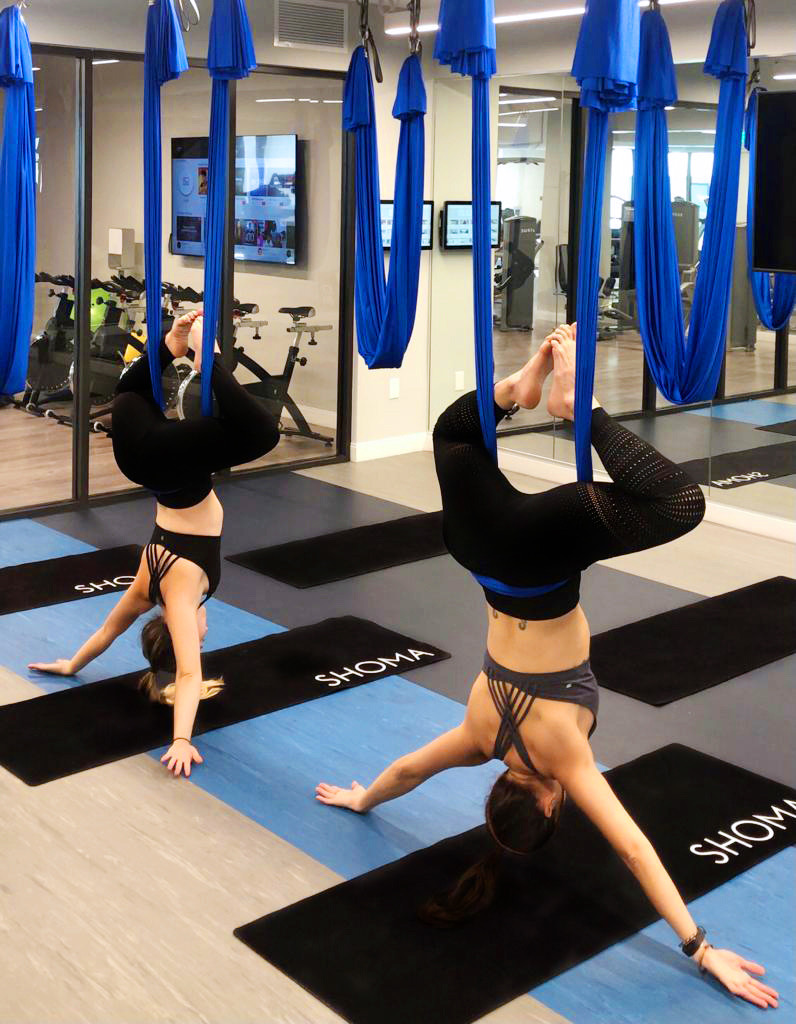Two women doing aero yoga