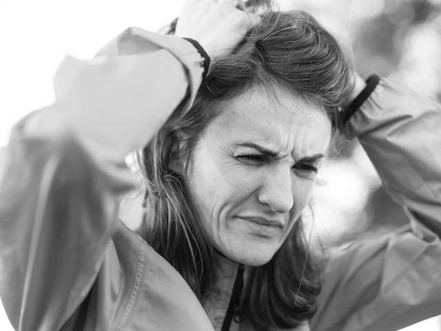 Woman scratching her head in frustration