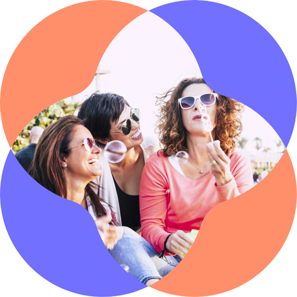 Three women of menopause age embracing and smiling