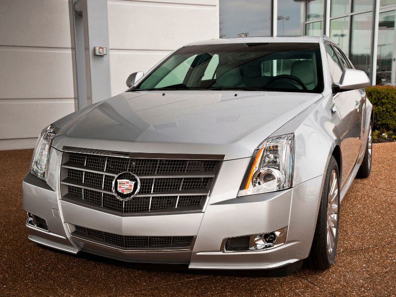 Silver Cadillac in showroom.