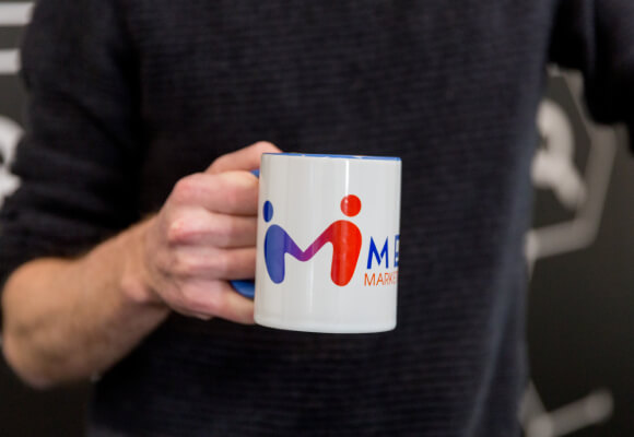 A man holding up a mug