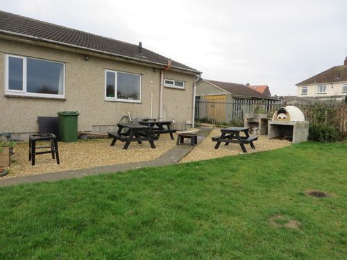 Picnic benches and pizza oven outside the scout hut