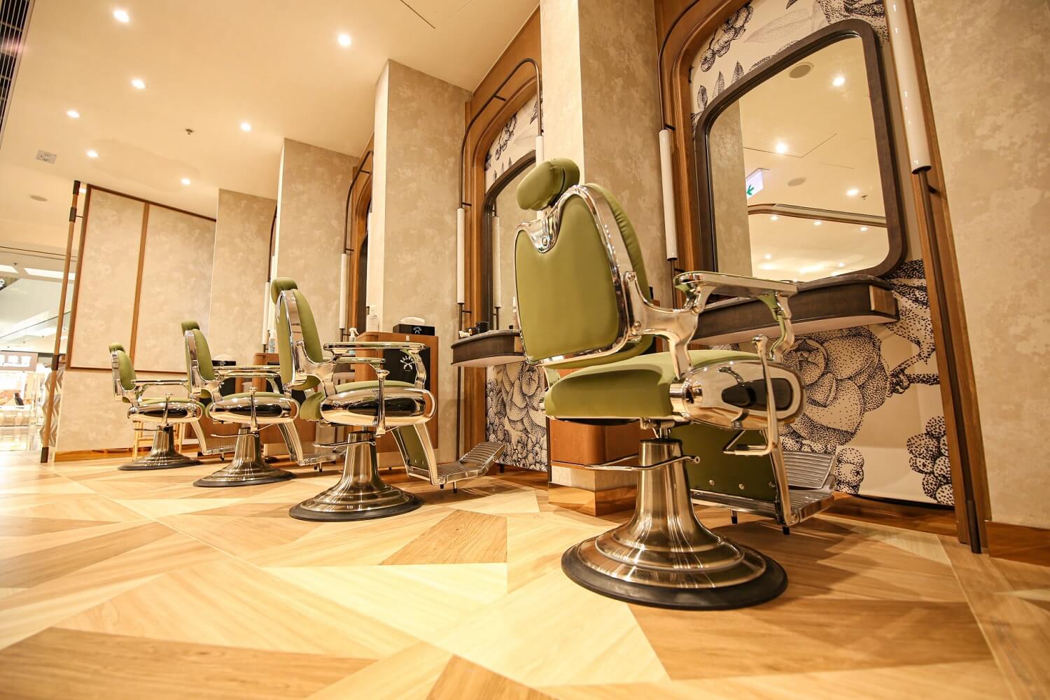 A row of elegant barber shop chairs and mirrors inside the Saloon Festival Walk shop.