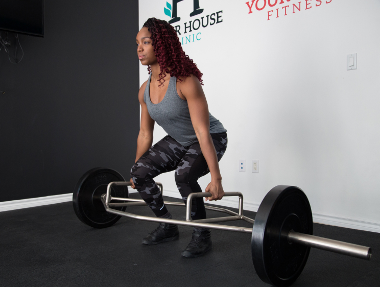 Person performing a deadlift using a trap bar