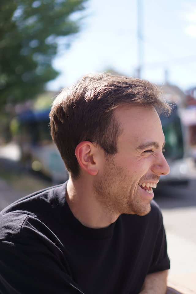 A smiling white man with facial hair