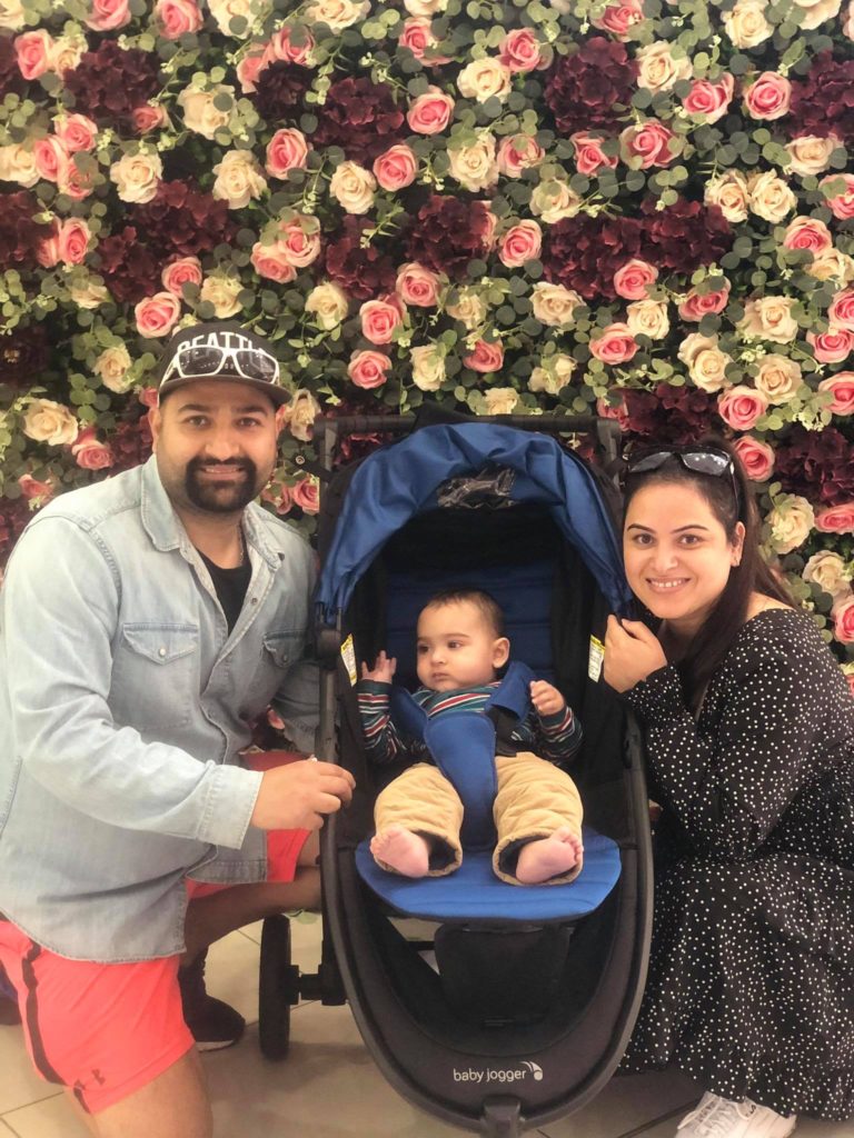 Sammy and pam with his baby and beautiful flowers