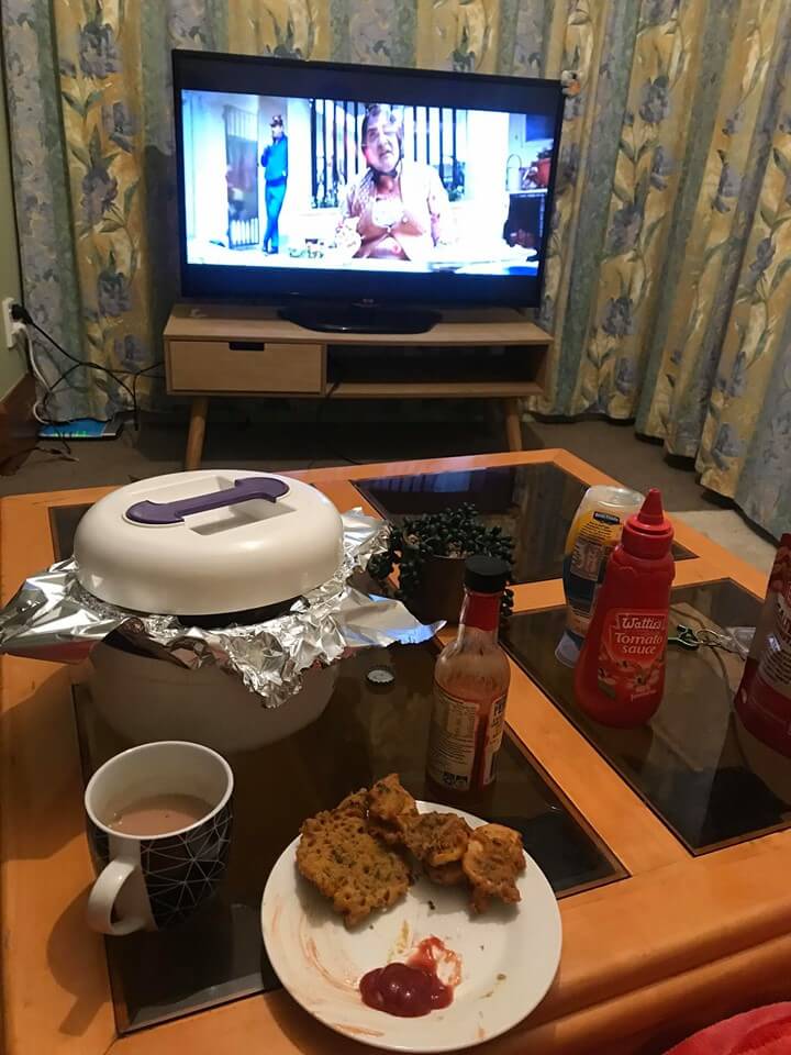 Pam watching tv with favorite dishes