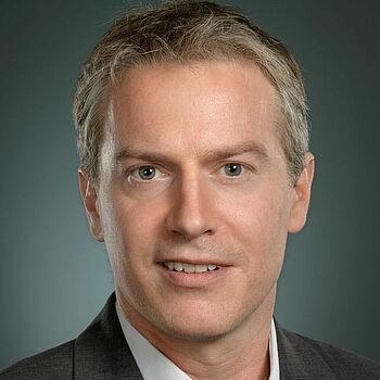 A person in a suitDescription automatically generated