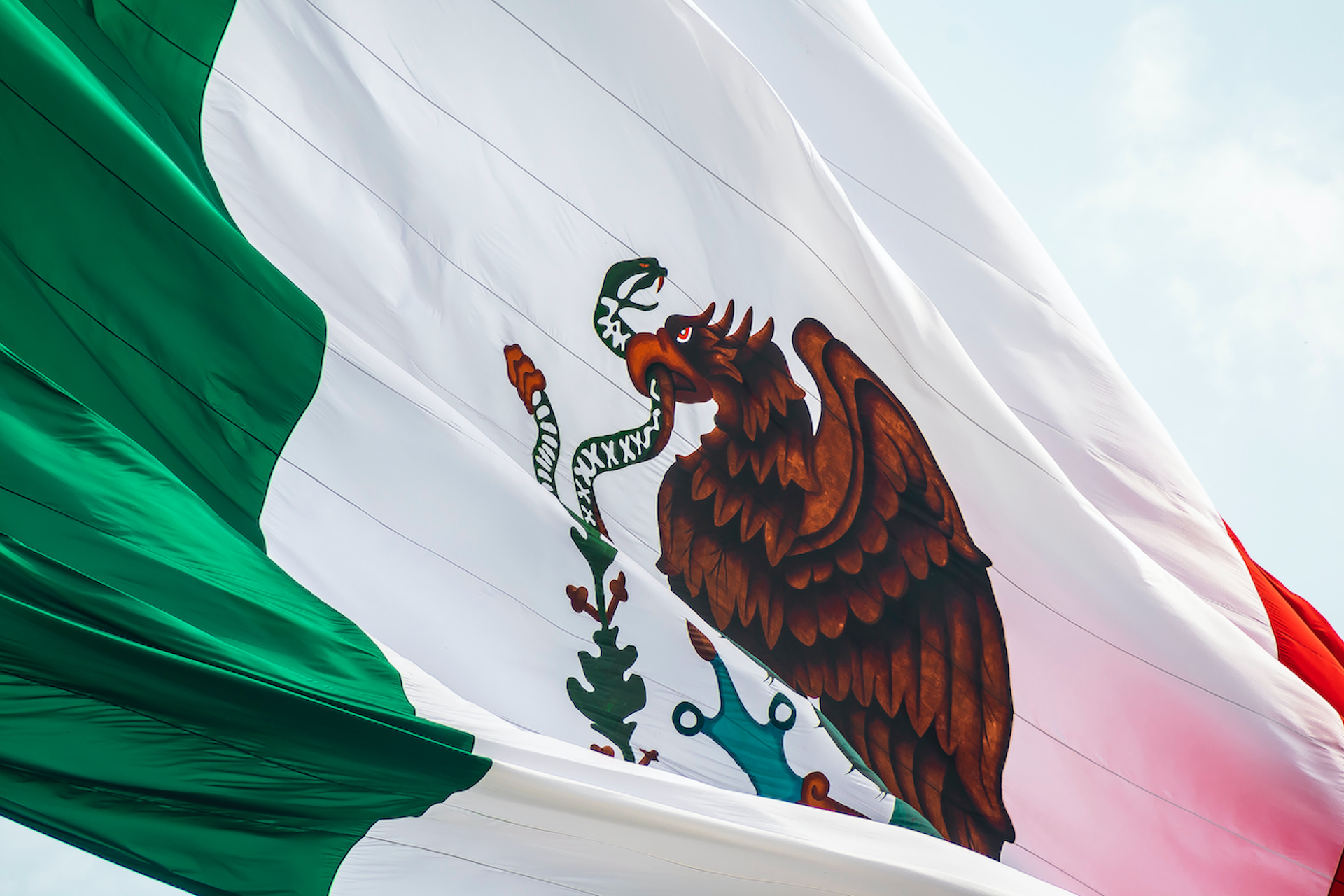 Flag of Mexico waving in the foreground