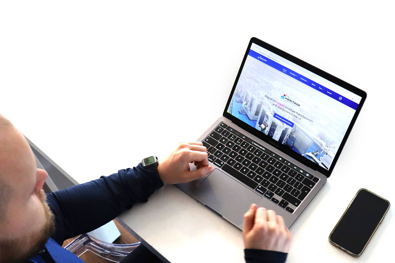 Steve designing a website on a laptop.