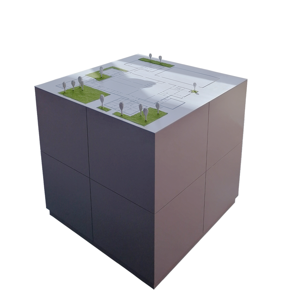A cube-shaped white table with a stylized map of Campus Münchberg printed on its top. It is decorated with some low-poly-styled, white plastic trees and patches of green artificial grass.