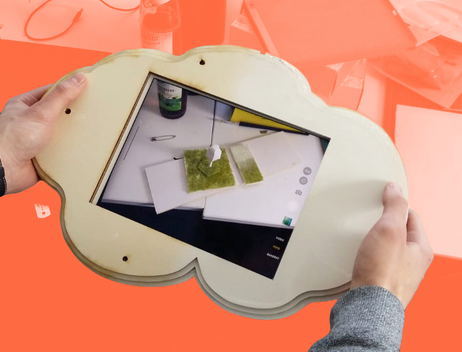 A wooden prototype of the cloud-shaped iPad case containing an iPad.