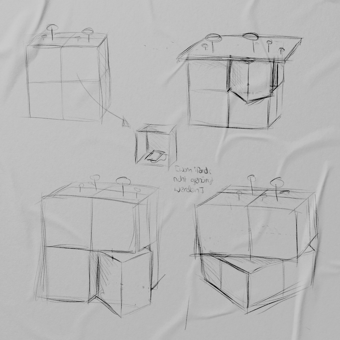A sketch showing four drafts of the exhibit's main furniture which is a table based on a cube. 