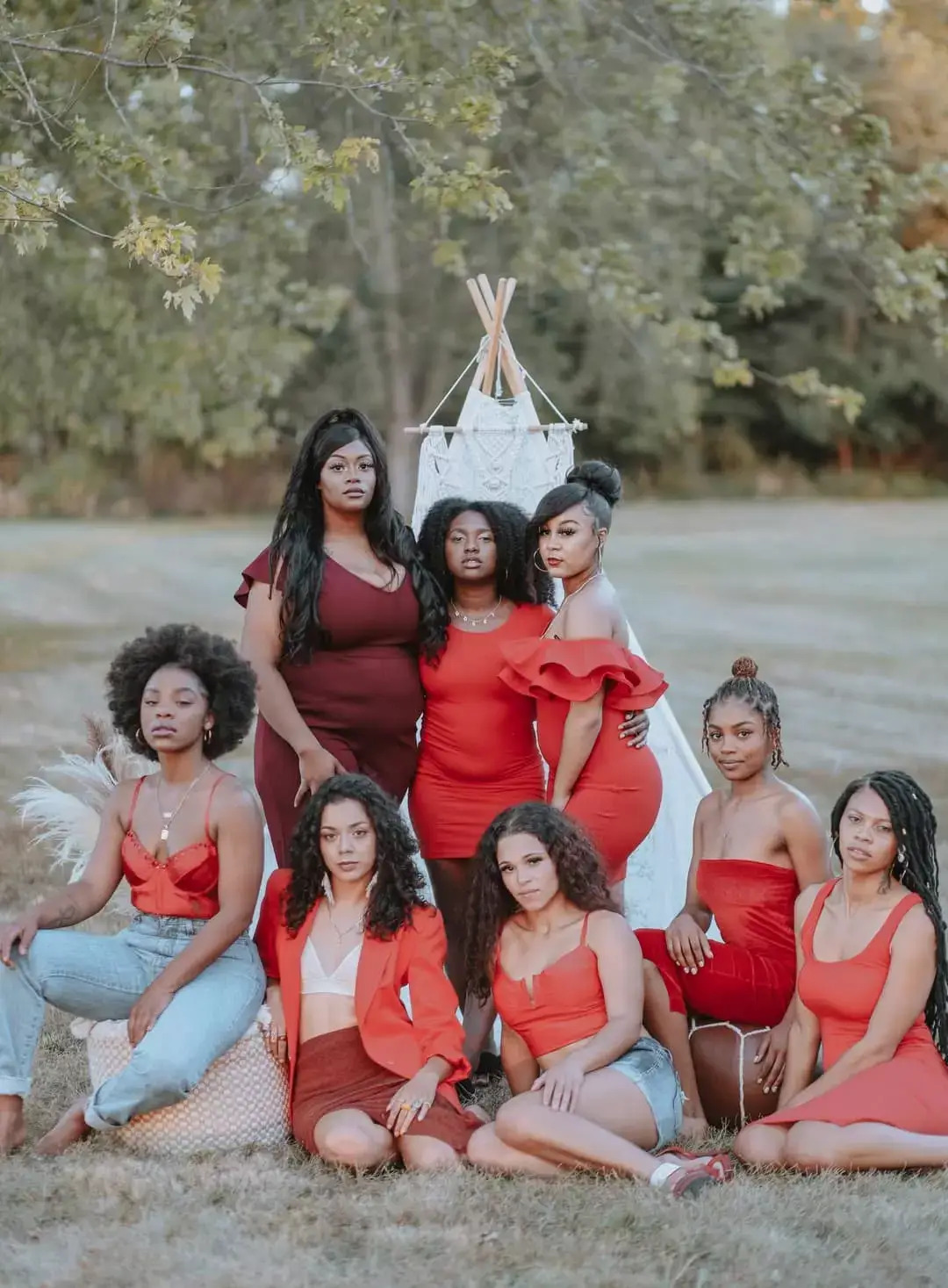Black women of all hues wearing red in a wooded area