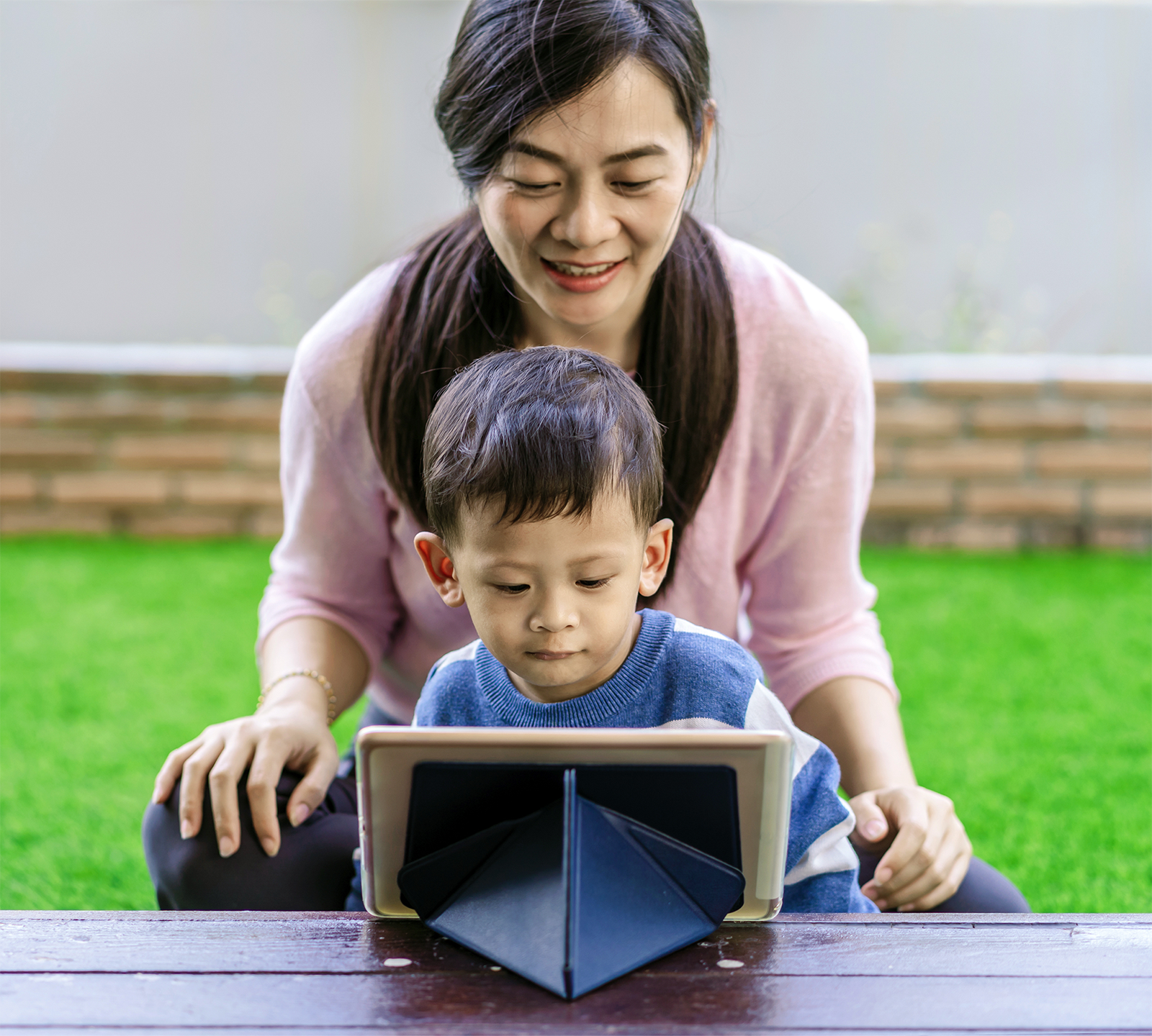 Photo of mom and son talking with a Jigsaw Diagnostics representative via a tablet