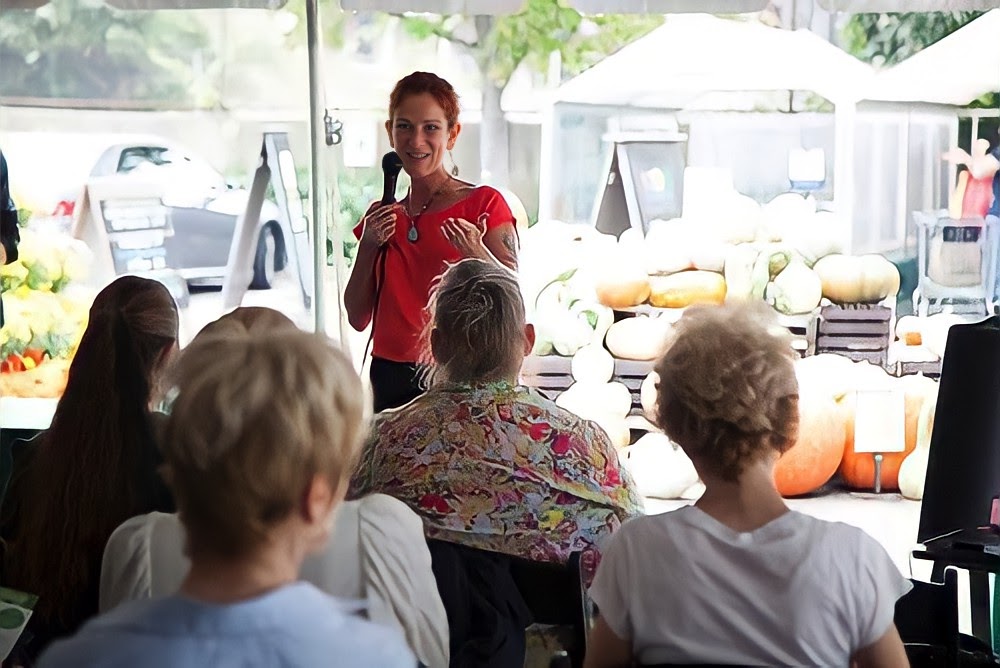 Mandi speaking to audience of people