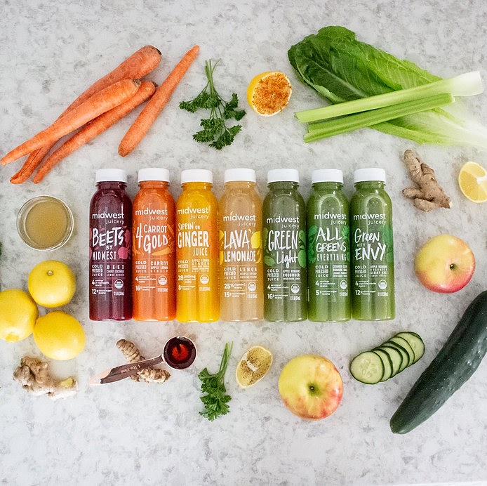 Colorful juices lined up on a counter