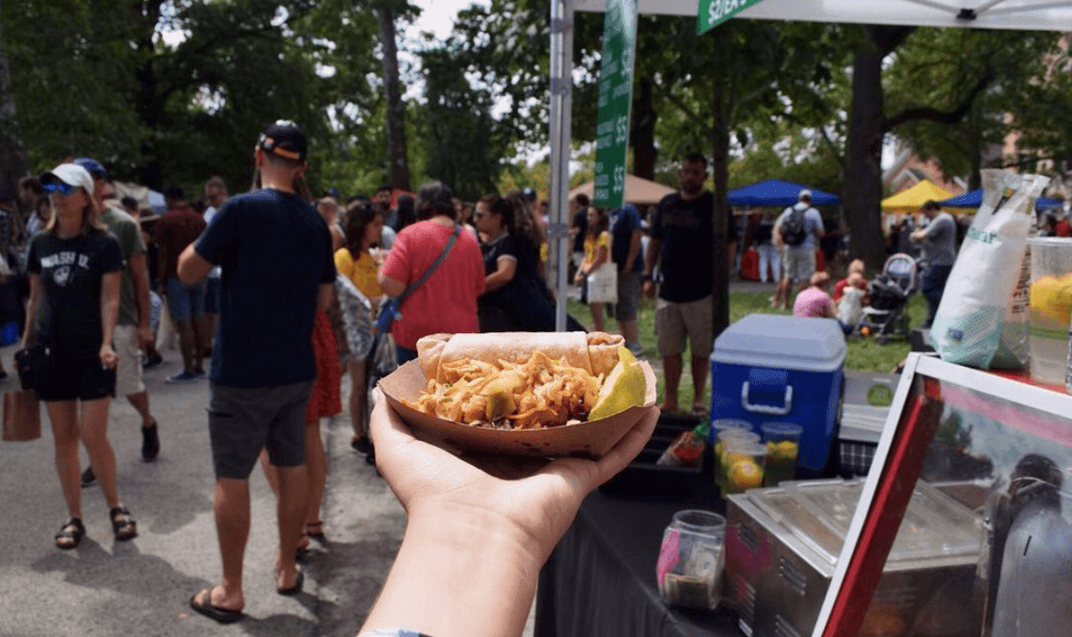 Hand holding out food