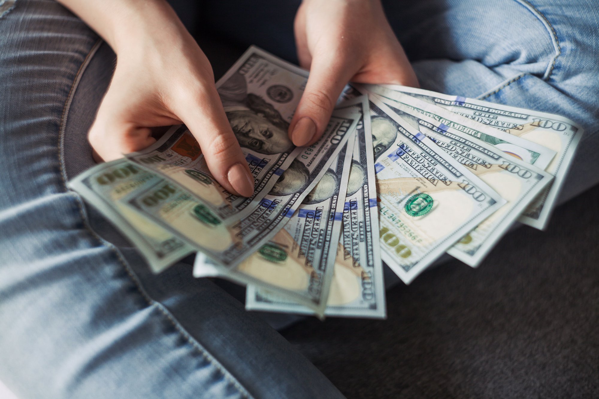 economic insecurity woman holding money