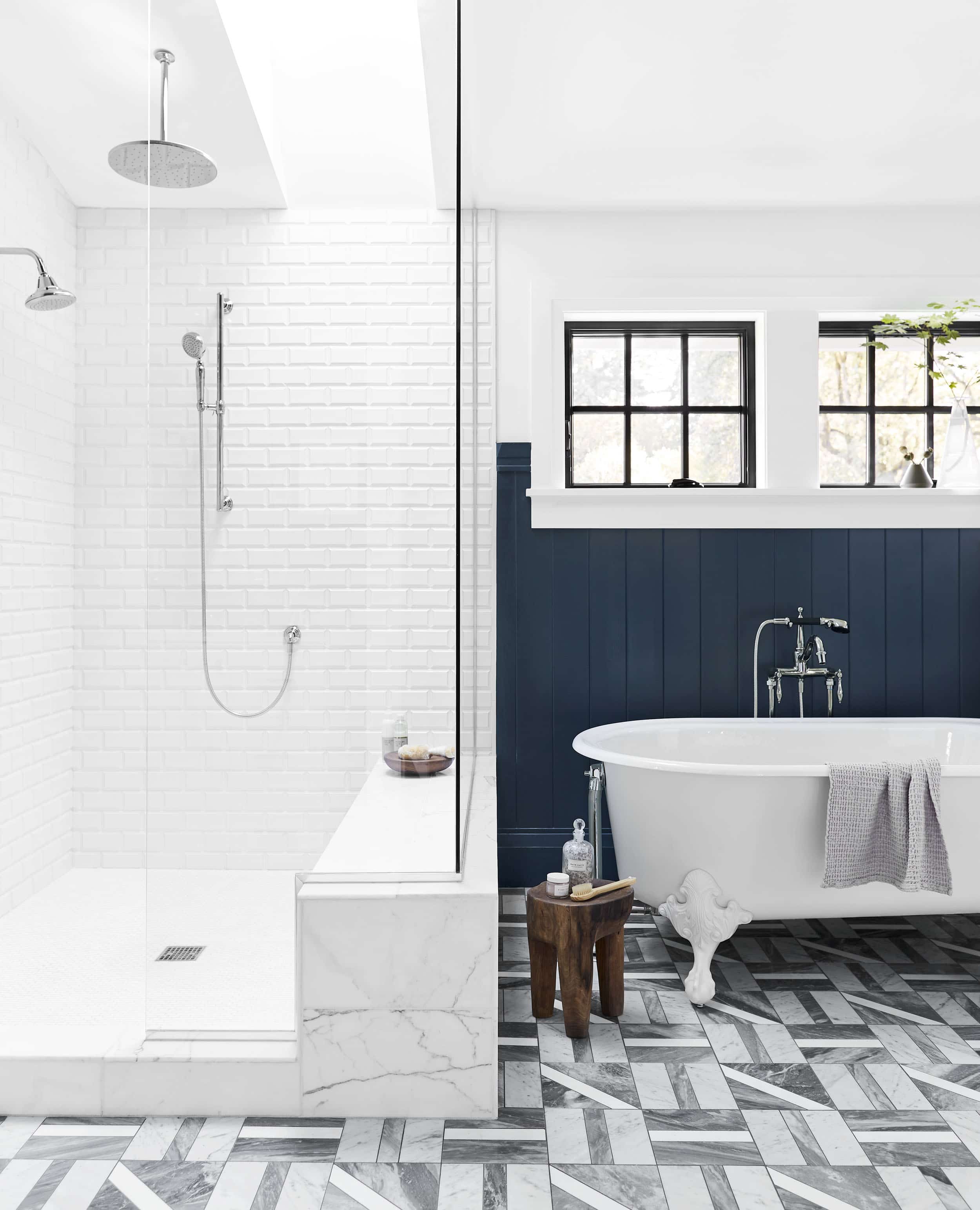Primary bathroom with gray marble tile floor and white subway tile shower