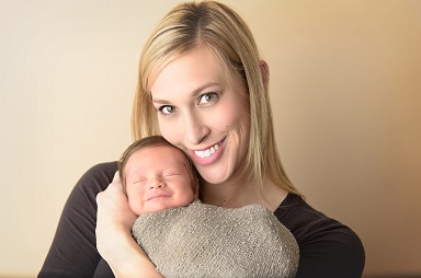 A photograph of a mom holding baby