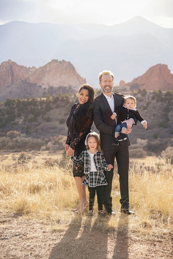 A photograph of a family of four against Garden of the Gods background
