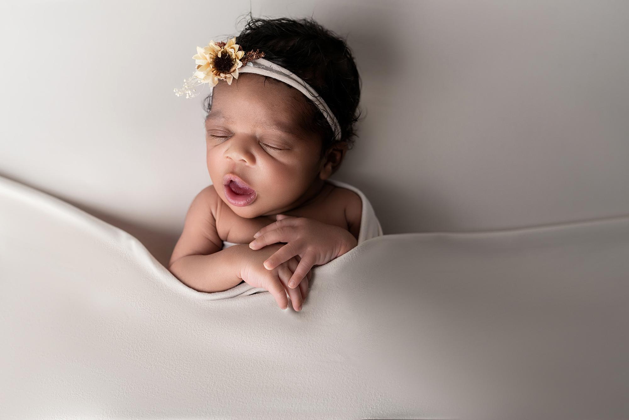A yawning newborn baby
